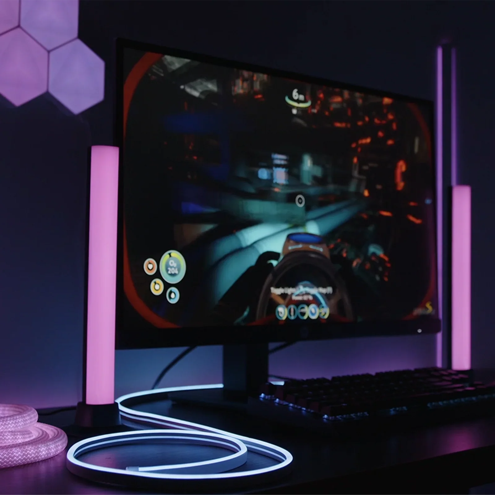 Gaming setup with immersive RGB LED lighting, pink light bars, and a curved monitor
