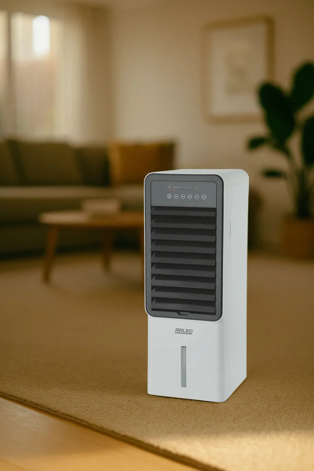 Arlec evaporative cooler on carpet in modern living room with sofa, table, and indoor plant